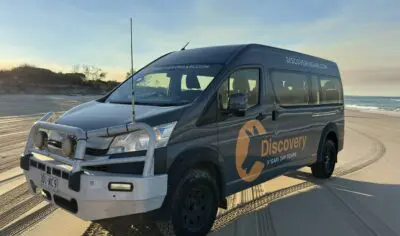 a black van parked on a beach