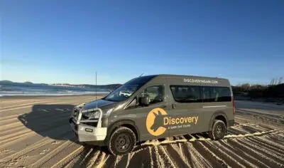 a black van parked on a beach