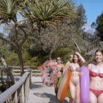 a group of friends having fun with inflatable tubes on a sandy stairs