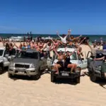 a group of friends having fun with on a 4wd on K'gari Fraser Island