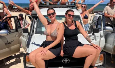 a group of friends having fun with on a 4wd on K'gari Fraser Island