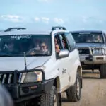 a group of friends having fun with on a 4wd on K'gari Fraser Island