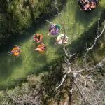 backpackers exploring K'gari on inflatables on a river Peterpans