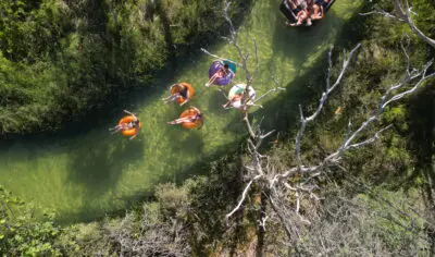 backpackers exploring K'gari on inflatables on a river Peterpans