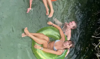 a group of friends having fun with inflatable tubes on a river