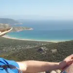 Traveller in a straw hat relaxing and admiring the stunning bay views at Wilsons Promontory during a 1 Day Go West Tours trip.