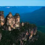Discover the iconic Three Sisters rock formation soaring above Blue Mountains cliffs on a 1 Day Blue Mountains Tour under clear skies.