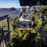 Experience a scenic cable car ride on a 1 Day Blue Mountains Tour, soaring high above lush valleys with breathtaking mountain views.