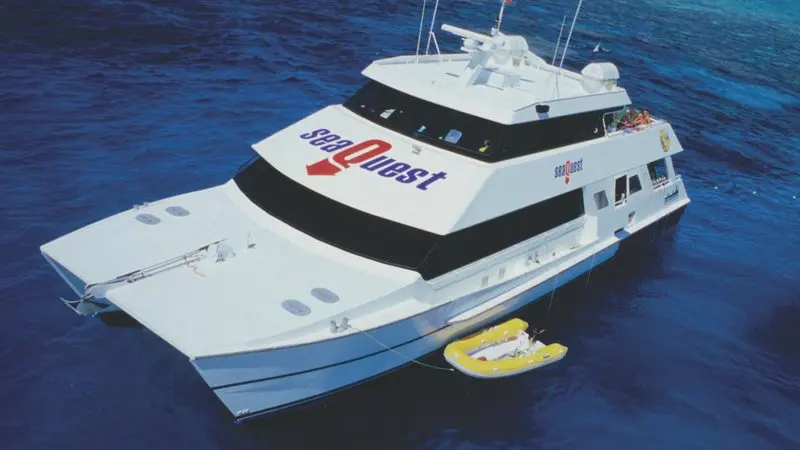 Luxury SeaQuest catamaran yacht anchored on vibrant blue waters during an Outer Reef Day Trip, perfect for snorkelling and adventure seekers.