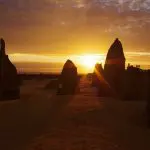 Spectacular tall limestone pinnacles glowing at sunset on the Perth to Exmouth tour, highlighting WA’s iconic desert landscapes.