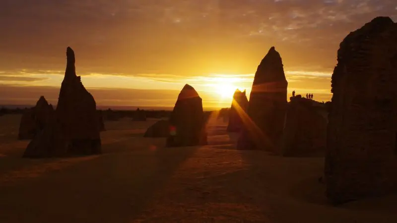 Spectacular tall limestone pinnacles glowing at sunset on the Perth to Exmouth tour, highlighting WA’s iconic desert landscapes.