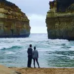 Two travellers discover scenic rocky cliffs and golden sands on the 1 Day Great Ocean Road Tour with Go West, Australia’s coastal wonder.
