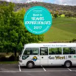 Go West Yarra Valley Grazing Tour white coach by scenic vineyards; Best in Travel Experiences 2017 award badge displayed above.