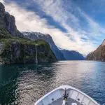 Image of boat cruising through Milford Sound