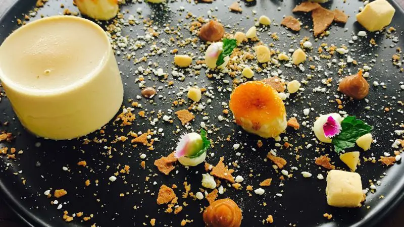 Indulge in the Ultimate Gourmet Tasting Experience—assorted desserts beautifully plated on a sleek black dish, Gold Coast-style.