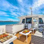 Exclusive luxury yacht deck on Sydney Harbour Vivid Lights Cruise, featuring gourmet canapés, premium drinks, and stunning ocean views.