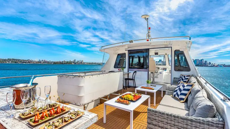 Exclusive luxury yacht deck on Sydney Harbour Vivid Lights Cruise, featuring gourmet canapés, premium drinks, and stunning ocean views.