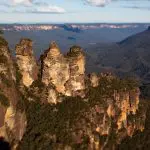 Discover breathtaking views of towering sandstone rock formations above lush forests during a Blue Mountains Sunset Wilderness Tour.