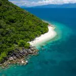 Stunning aerial view of Fitzroy Island, showcasing lush greenery, pristine sandy beaches, and crystal-clear turquoise waters.