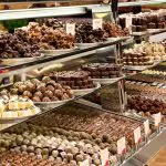 Glass display case brimming with luxury handcrafted chocolates, ideal treat following a relaxed Yarra Valley Winery Tour experience.