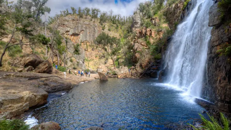 Majestic waterfall plunges into a scenic rocky pool, a must-see on the 3 Day Great Ocean Road Melbourne to Adelaide Explorer tour.