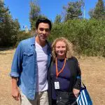 Smiling man in a blue shirt and woman with curly hair enjoying an outdoor Celebtime Tours adventure experience under sunny skies.