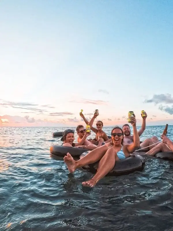 a group of friends having fun in a floating ring on a trip to Fiji