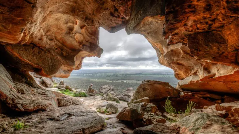 Breathtaking view from inside a rocky cave on the famous 3 Day Great Ocean Road Adelaide to Melbourne Overland Journey, Australia.