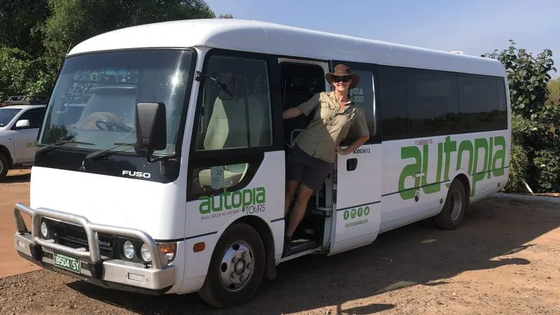 Traveller in a hat and sunglasses by Autopia Tours minibus on Darwin’s Half-Day Jumping Crocodile Tour, ready for adventure.