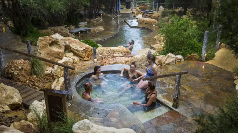 Relax at Peninsula Hot Springs as six guests enjoy a stone spa; includes 1 Day Spa Entry and convenient shuttle bus service.