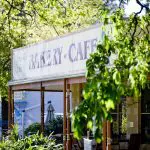 Inviting bakery café sign on a sunny patio, ideal for a delicious pre-tour stop before your Lake Mountain Snow Waterfalls adventure.