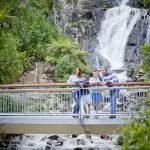 Family of four admires breathtaking bridge view on Lake Mountain Snow Waterfalls 1 Day Tour from Melbourne, perfect getaway.