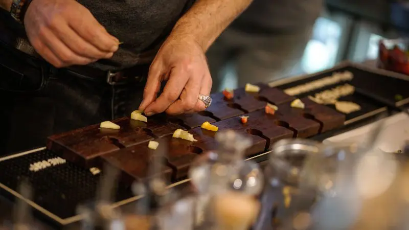 During a 10-Day Adelaide to Perth Adventure Tour with Untamed Escapes, fresh fruit is artfully arranged on a rustic wooden board.
