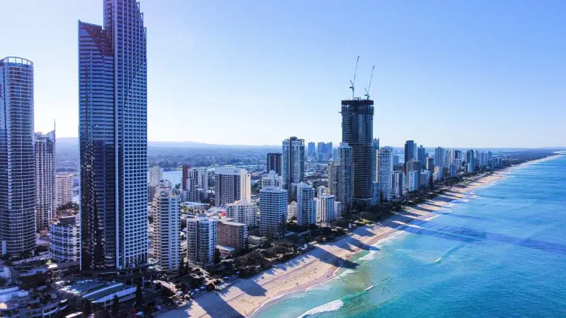 Stunning aerial view of Sydney to Brisbane coastline, featuring towering skyscrapers and golden sandy beaches on the Oz Intro 10 Day tour.