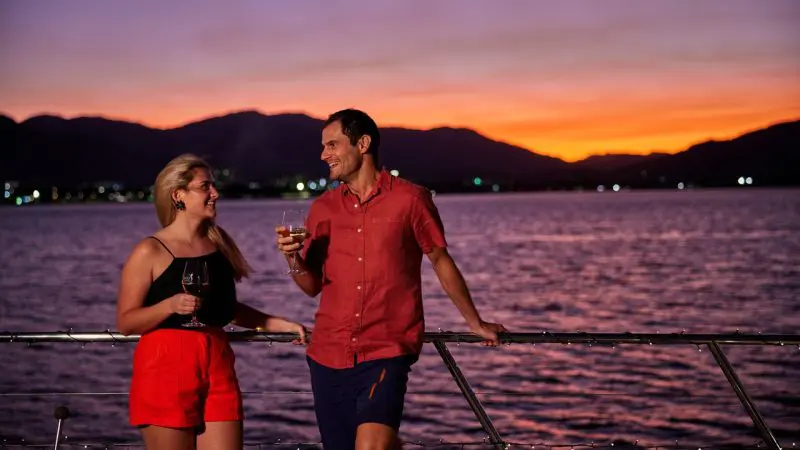 Couple On the Spirit of Cairns enjoying a drink during sunset