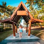 Woman exploring wooden pavilion during Fully Guided Ultimate East Coast Sydney to Cairns 3 Weeks 2 Tour Adventure, Australia.