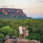 A couple explores rocky terrain at sunset on a 5 Day Kakadu, Katherine Gorge & Litchfield 4WD Adventure departing from Darwin.