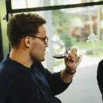 Traveller savouring premium red wine indoors during a luxury 1 Day Hunter Valley Wineries Tour from Sydney by Colourful Collective Travel.