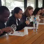 Guests on a 1 Day Hunter Valley Wineries Tour from Sydney with Colourful Collective Travel savour premium wines and review tasting notes.