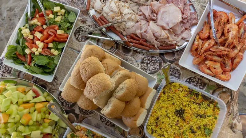 Overhead shot of delicious assorted dishes served after Big Fury Whitsundays Full Day Whitehaven Beach tour, vibrant and inviting.