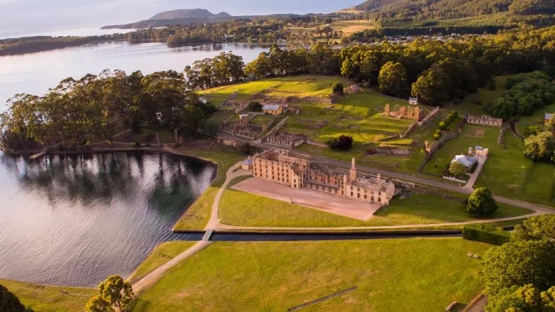 Stunning aerial view of historic stone building along Port Arthur Harbour, ideal for Tasman Safaris Cruise and Lunch experience.