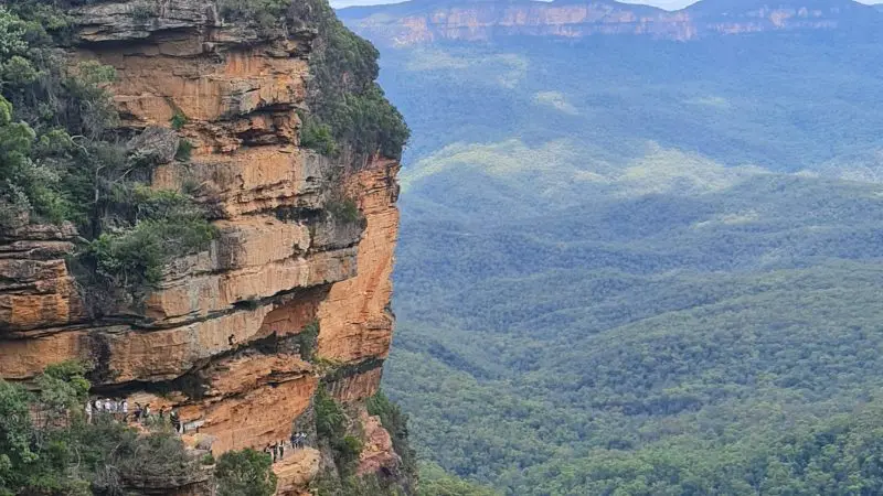 Stunning cliffside trail with panoramic Blue Mountains valley views, scenic waterfall walk, and a delightful social lunch on your day tour.