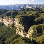 Stunning aerial panorama of lush, rugged Blue Mountains cliffs on a 1 Day Wildlife Park Trip beneath a vibrant clear blue sky.