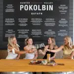 Four women clinking wine glasses at a table on a 1 Day Hunter Valley Wineries Tour from Sydney with Colourful Collective Travel.