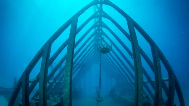 High-resolution underwater image of a boat-shaped metal sculpture on the Great Barrier Reef seen during a Townsville MOUA tour.