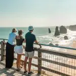 Three travellers on a wooden lookout admire stunning sea stacks, capturing the essence of Melbourne’s top coastal adventure experience.