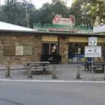 Grants Café and souvenir shop feature outdoor tables, signage, lush trees, and scenic views from Rayners Orchard Tour 1 experience.