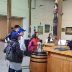 Wine enthusiasts experience Yarra Valley wine tasting at a rustic winery, engaging with expert staff for premium Australian wines.