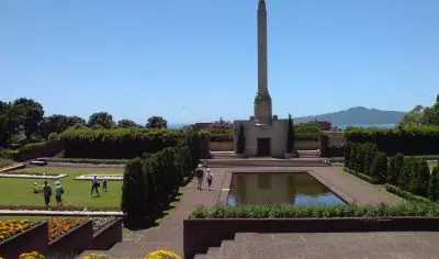 Discover a striking stone obelisk set in a lush landscaped garden—an iconic, must-see Auckland City tour attraction.