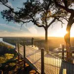 Capture the breathtaking sunrise over a river and valley from a lookout on a 1 Day Blue Mountains Sunset Wilderness Tour.